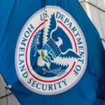 Flag of the U.S. Department of Homeland Security displayed on a building