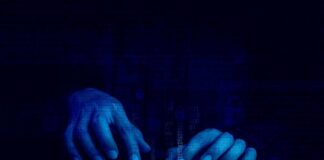 Hands typing on a keyboard with a digital binary background