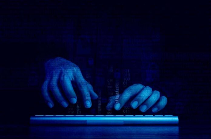 Hands typing on a keyboard with a digital binary background