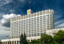 Government building with a Russian flag under a cloudy sky