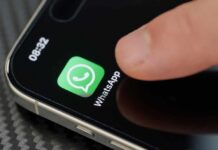 SHOCKING Claim: WhatsApp’s Encryption a Ruse? Finger tapping the WhatsApp icon on a smartphone screen