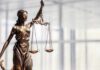 Bronze statue of Lady Justice holding scales and a sword