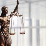 Italy SHIELDS Accused Killer From Texas Justice Bronze statue of Lady Justice holding scales and a sword