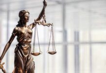 Bronze statue of Lady Justice holding scales and a sword