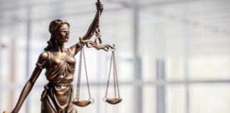Bronze statue of Lady Justice holding scales and a sword