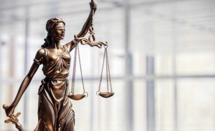 Bronze statue of Lady Justice holding scales and a sword