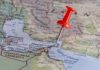 A red pushpin on a map of the Middle East highlighting a specific location