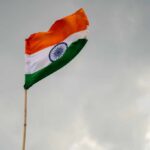 Unyielding India: LNG Tanker Held Off Singapore Indian flag waving against a cloudy sky