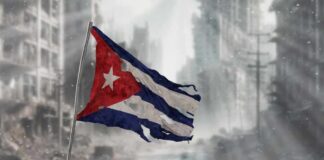 Tattered Cuban flag waving over a pile of rubble in a devastated urban landscape
