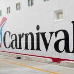 Carnival Horizon cruise ship docked near a city skyline