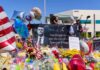 A memorial site with flowers, balloons, and a large photo honoring Charlie