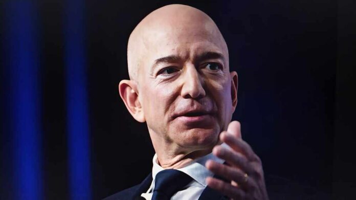 A bald man in a suit speaking at a conference