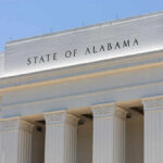 Facade of a government building with the words 'STATE OF ALABAMA' displayed prominently