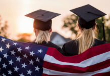 Parking Lot Patrols? Mom Scans Lot, Misses Milestone Two graduates wearing caps holding an American flag during sunset