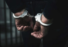 Hands in handcuffs behind the back