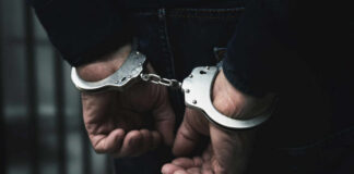 Hands in handcuffs behind the back
