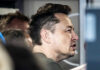 Progressive Meltdown Over Musk’s Trillion Close-up of a man engaged in conversation indoors