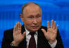 A political leader gesturing with hands during a press conference