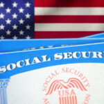 Social Security cards in front of the American flag