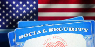Social Security cards in front of the American flag