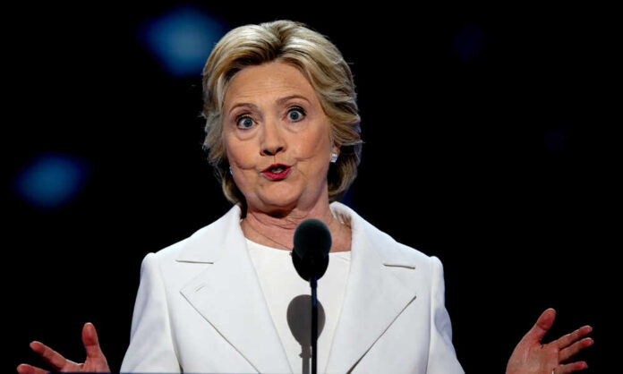 Philadelphia,Pennsylvania,,Usa,,28th,July,,2016,Former,First,Lady,Hillary A woman in a white suit speaking at a podium during a conference