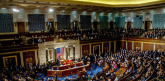 National Security Cliff — Congress Plays Chicken A large gathering of officials in a congressional chamber during a legislative session