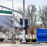 Pentagon Pipeline Moves Into Detroit Sign for Lockheed Martin Space Systems next to a traffic signal