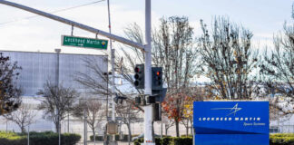 Sign for Lockheed Martin Space Systems next to a traffic signal