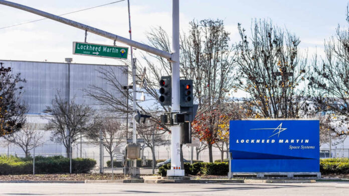 Sign for Lockheed Martin Space Systems next to a traffic signal