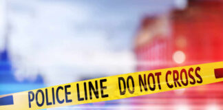 Yellow police tape reading DO NOT CROSS at a crime scene