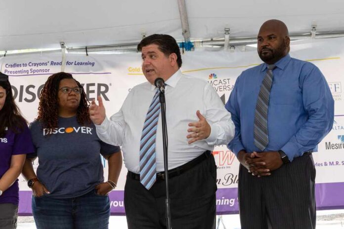 man speaking at a podium with three people standing beside him