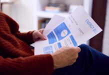 Person reviewing an energy bill with detailed information