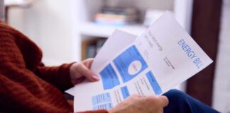 Person reviewing an energy bill with detailed information