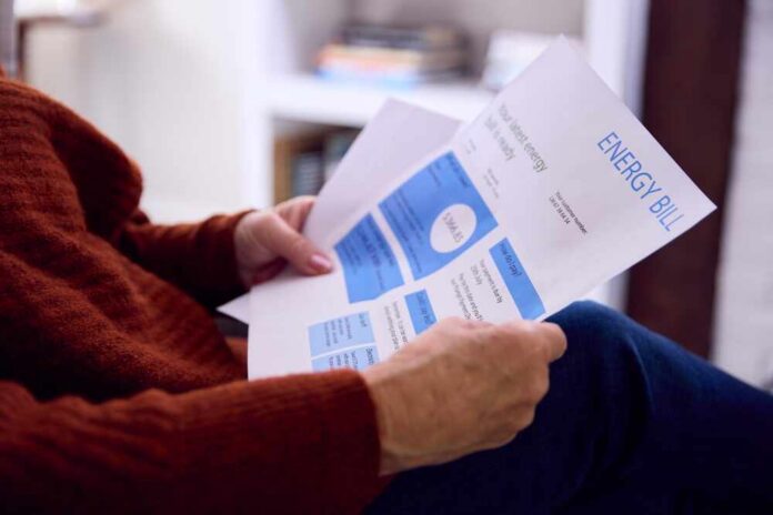 Close,Up,Of,Senior,Woman,At,Home,Looking,At,Usa Person reviewing an energy bill with detailed information