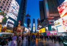 Crowd of people in Times Square surrounded by bright advertisements and buildings