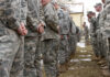 Apache Downed — Washington Explodes A line of soldiers in military uniforms standing outdoors in formation