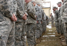 Apache Downed — Washington Explodes A line of soldiers in military uniforms standing outdoors in formation