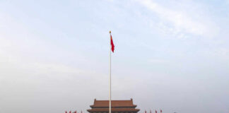 View of Tiananmen Square with the Chinese flag and historical buildings
