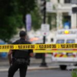 Deadly Crash Exposes NYC’s Scooter Law Mess Police officers near a crime scene marked by caution tape