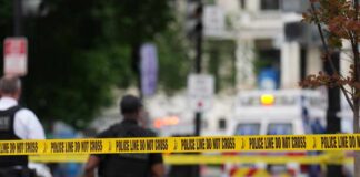 Deadly Crash Exposes NYC’s Scooter Law Mess Police officers near a crime scene marked by caution tape
