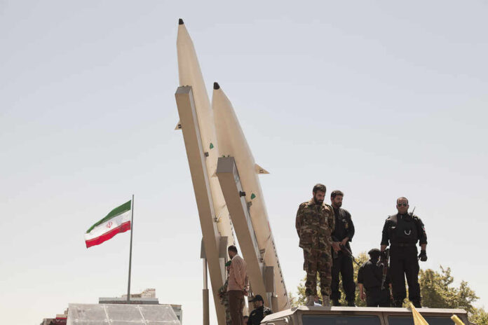 Quds,Day,Rally,,Display,Middleware,Missiles,,Zulfiqar,Rocket,,Iranian,Revolutionary Military personnel standing near missile launchers with an Iranian flag in the background