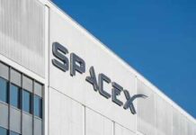 Falcon 9 Turns Space Into An Assembly Line SpaceX logo on a white industrial building facade