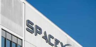 Falcon 9 Turns Space Into An Assembly Line SpaceX logo on a white industrial building facade