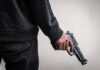 Tourist Camp Turns Deadly—Police Go Silent person holding a handgun at their side