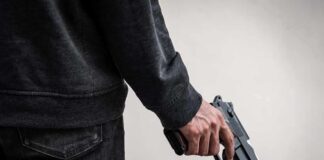 Tourist Camp Turns Deadly—Police Go Silent person holding a handgun at their side