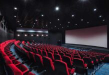 Woke Odyssey Sparks Conservative Brawl empty movie theater with red seats and large screen