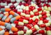 Assorted capsules in red, yellow, orange, and gray