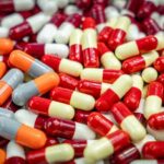 Assorted capsules in red, yellow, orange, and gray