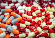 Assorted capsules in red, yellow, orange, and gray