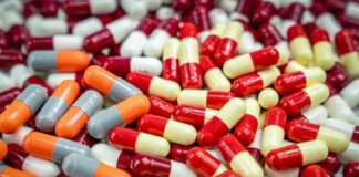 Assorted capsules in red, yellow, orange, and gray
